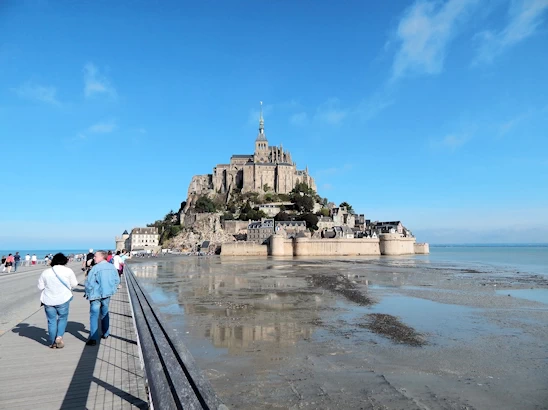 Experience the breathtaking beauty of Mont Saint-Michel on a day trip from Paris. This guide covers transportation options, must-see sights, and tips for making the most of your visit to this iconic island commune, famous for its stunning abbey and picturesque views