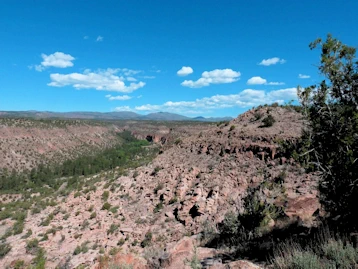 Explore cliff dwellings & hike through ancient history at Bandelier National Monument, NM. Unique multi-story homes & stunning Frijoles Canyon views. Ranger tours, wildlife & Jemez Mt beauty await!